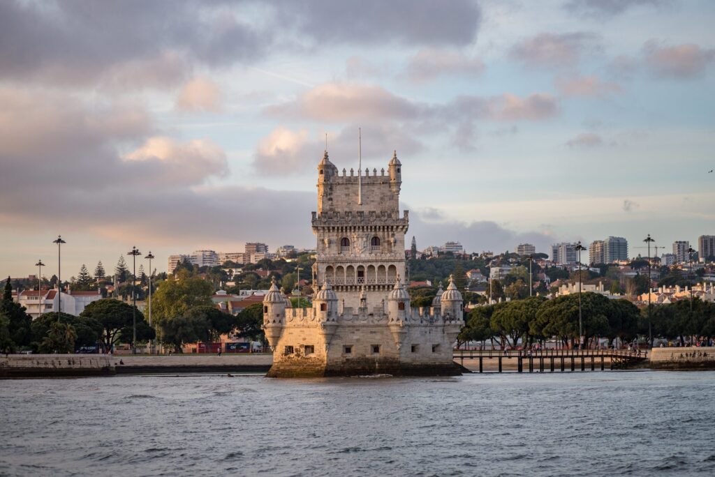 Tower belem surrounded by sea buildings cloudy sky portugal — Portugal